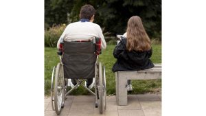 disabled-man-helping-girl-learn-i