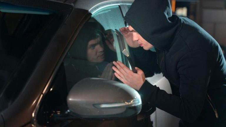 close-man-trying-break-car